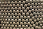 Photo of a close-up of spherical beige candy aligned in a lattice