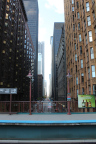 Photo of a street with tall buildings on either side creating a canyon effect