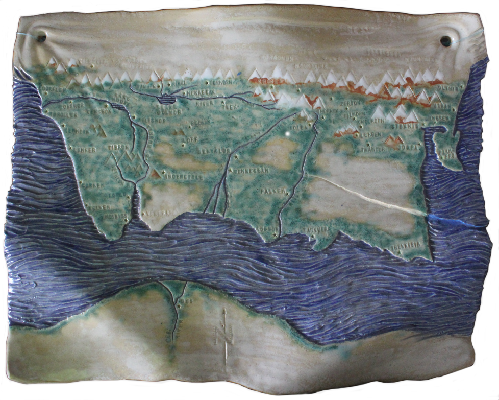 A ceramic map showing a blue sea below a green and brown land and above that a row of white and blue mountains