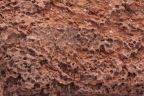 Photo of a close-up of pitted red sedimentary rocks